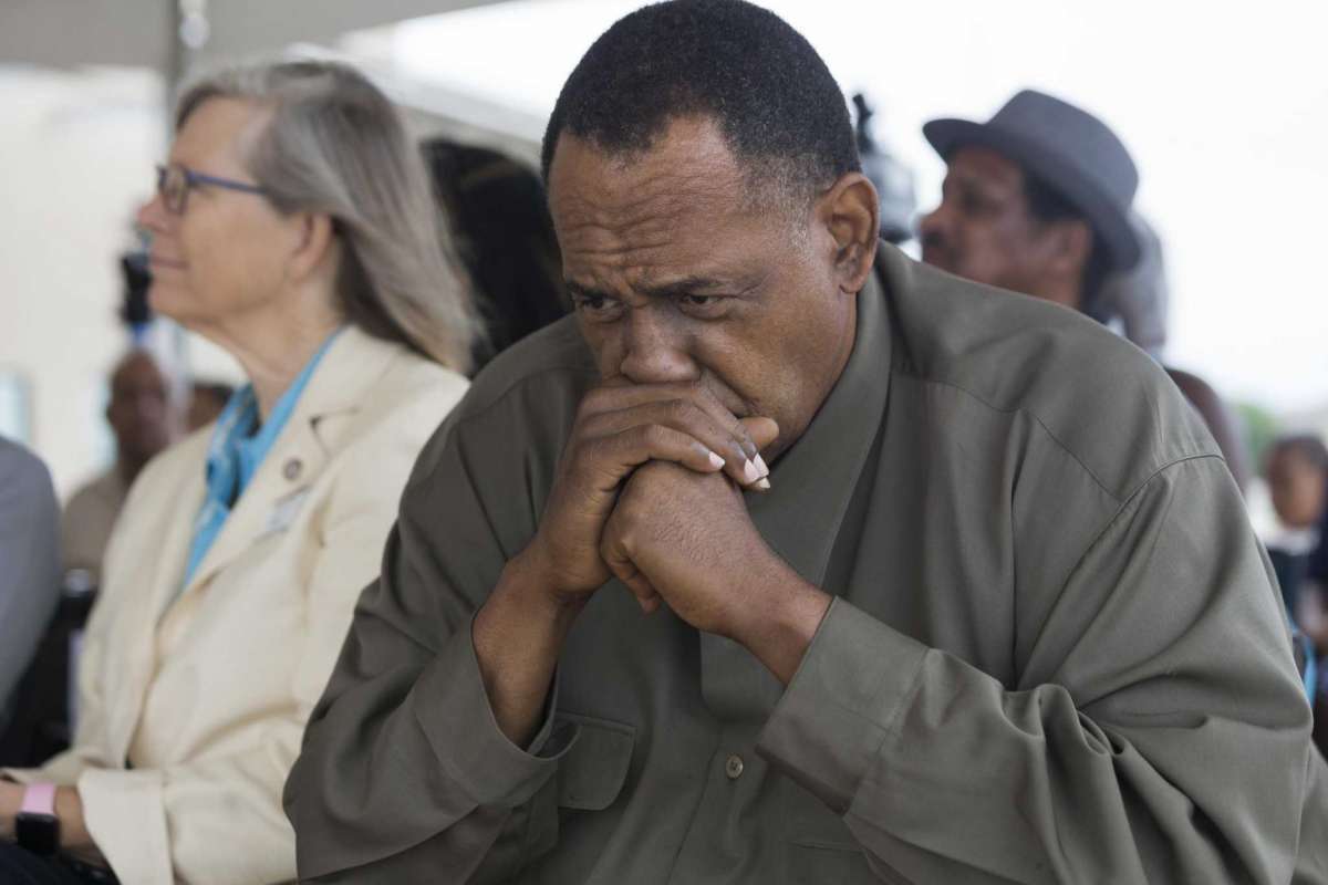 Activist Reginald Moore, right, listens to State Rep. Ron Reynolds, D-Missouri City, at a news conference celebrating progress on the Sugar Land 95 Memorial Project in Sugar Land, Monday, June 17, 2019.