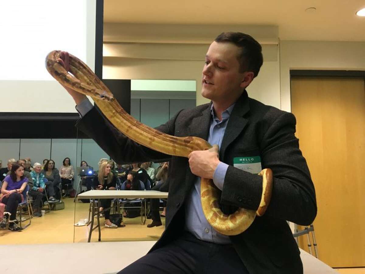 Jack Whalen holds a boa constrictor
