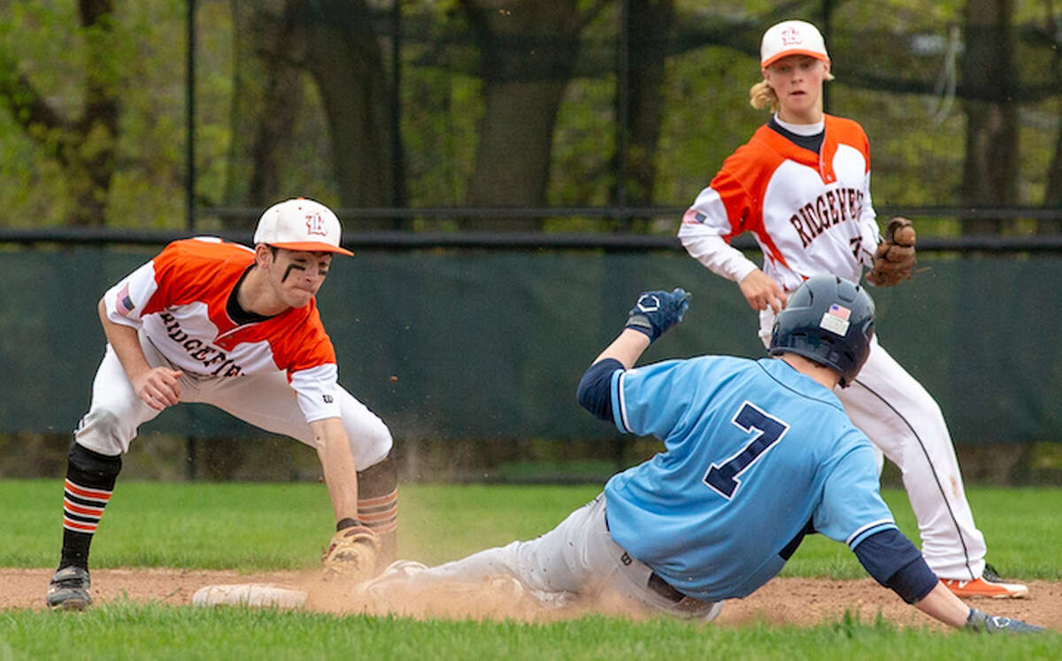 Bobby Arent puts the tag on Wilton's Kyle Phillips during Monday's baseball game. Backing up the play is Ridgefield shortstop Colin LaCoille. - GretchenMcMahonPhotography.com