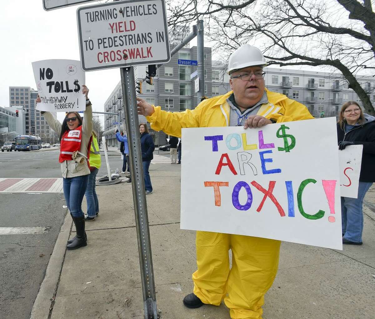 At right, Mike Johnson of New Canaan joins with others from the anti-toll group No Tolls CT, as they stage a protest in front of the Government Center on Saturday, Feb. 23, 2019 in Stamford, Connecticut.