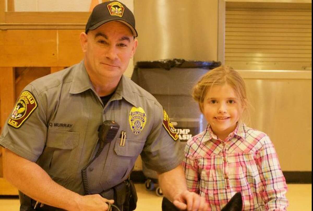 Ridgefield police Officer Sean Murray will be promoted to sergeant next week. He posed for a picture with Scotland Elementary School fifth grader Rilynn Mahoney last year.