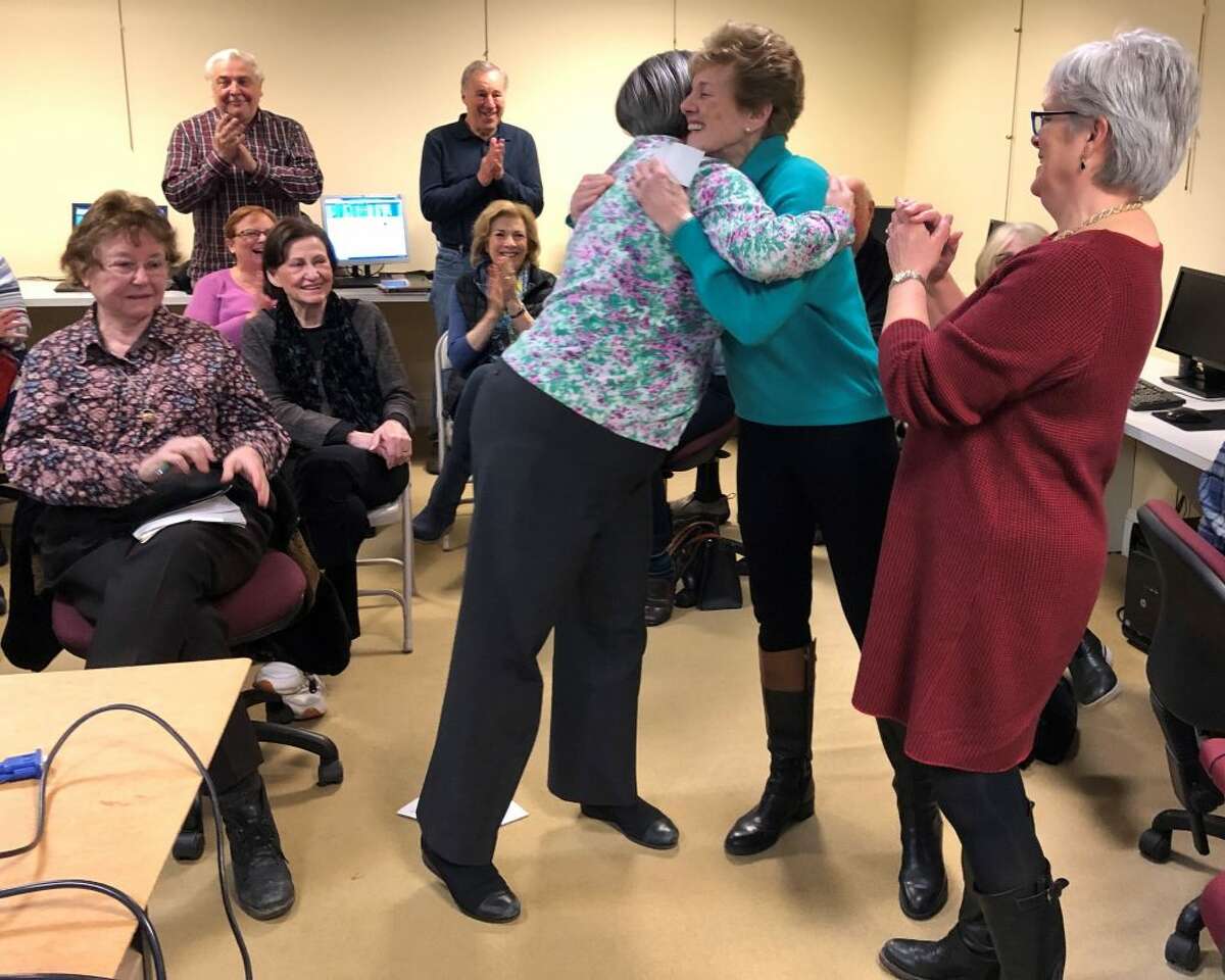 Grace Weber, Founders Hall executive director, excitedly looks on as Cindy Nesbitt, Founders Hall director of development, thanks Toni Maiolo from Ridgefield Thrift Shop for their generous gift.