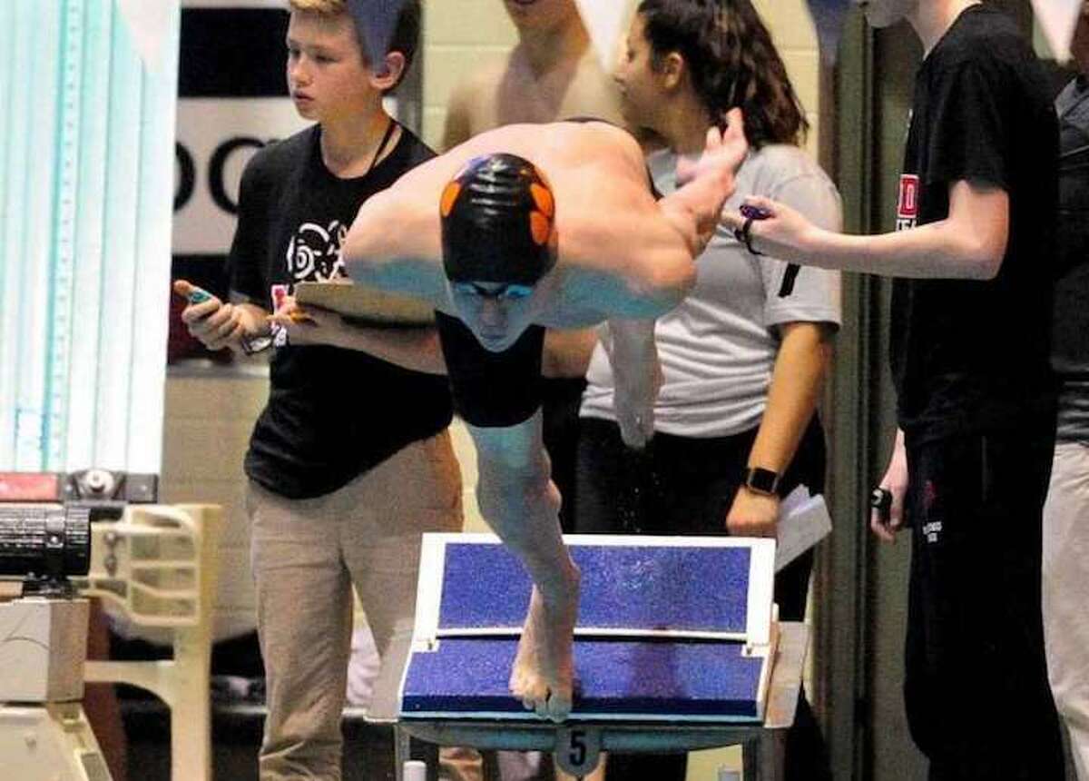 Will Bryant prepares to enter the water for the 50-yard freestyle at the State Open meet. Bryant finished first in the race. Photo: Christian Abraham / Hearst Connecticut Media