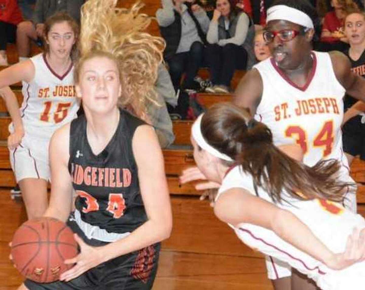 Kate Garson eyes the basket during Ridgefield's win over St. Joseph. - Andy Hutchison photo