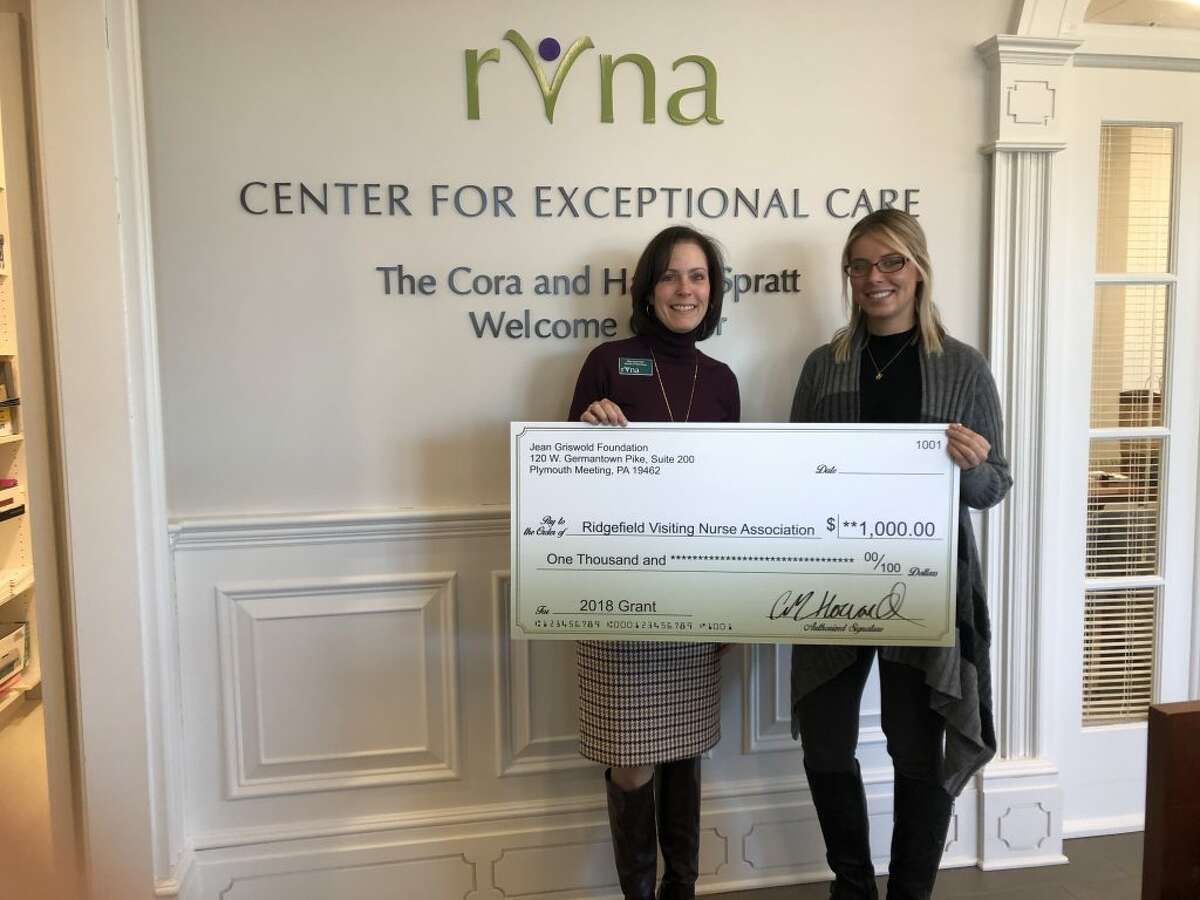 Mary Jean Heller, director of philanthropy for the RVNA, receives a $1,000 grants check from Kelly Coy, case manager at Griswold Home Care.