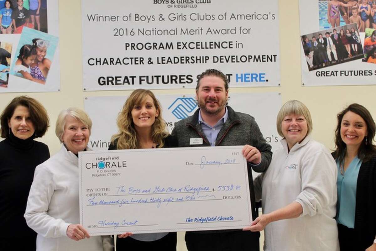 Annette Hewko, Amy Y. Day, Jess Murphy, Mike Flynn, Daniela Sikora, and Tauna Idone stand together with the check from the Ridgefield Chorale to the Boys and Girls Club.