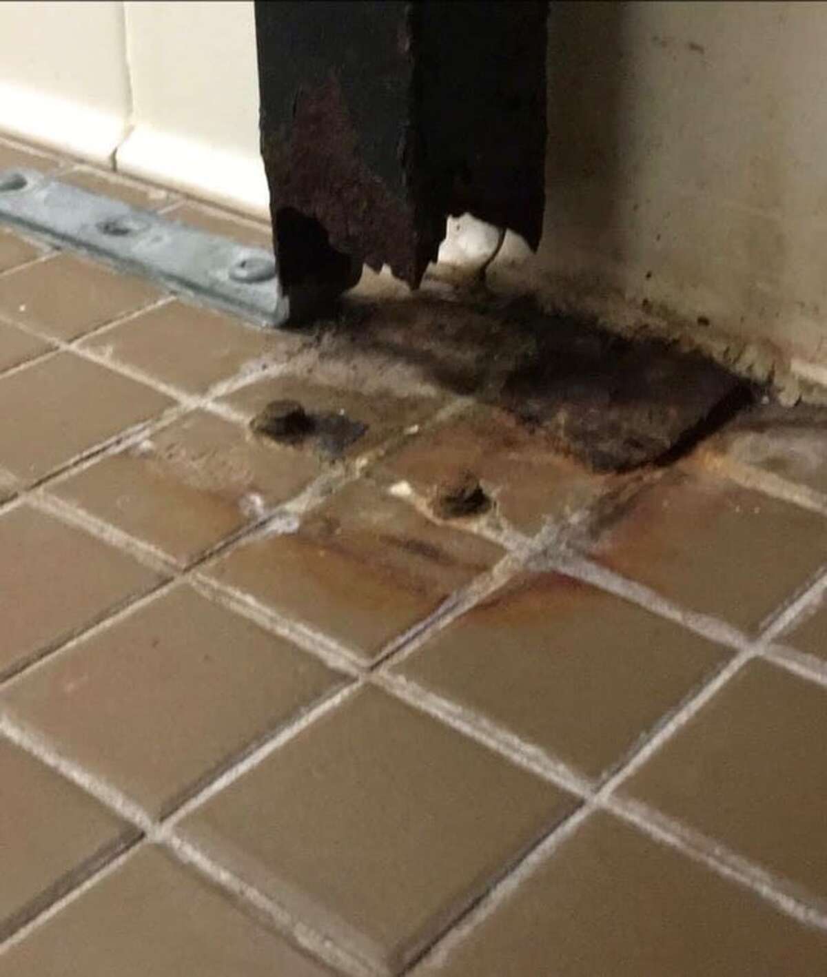A stall in one of the girls bathrooms at Ridgefield High School shows corrosion. The school board is looking to accelerate infrastructure repairs.