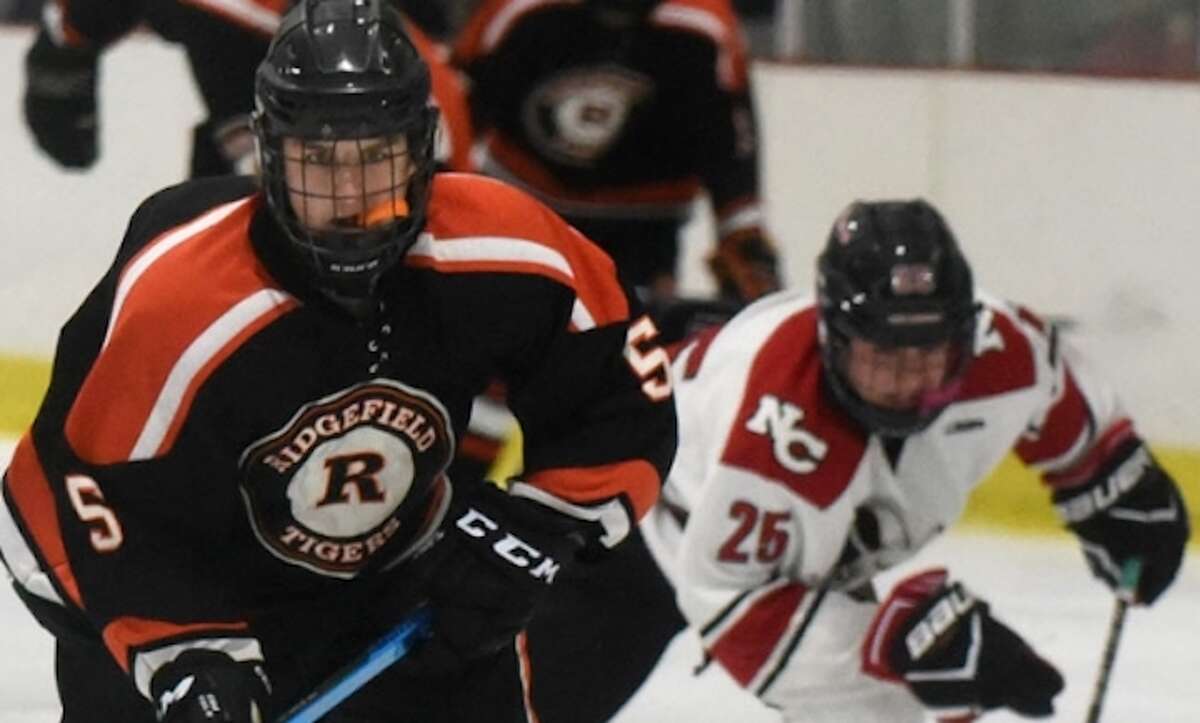 Henry Garlick skates past a New Canaan player during Ridgefield's 6-1 win Tuesday night. — Dave Stewart photo