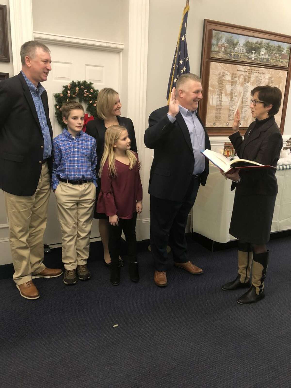 Wayne Floegel, second to the right, was sworn in as the new Republican Registrar on Friday, Jan. 4, by Town Clerk Wendy Lionetti, far right. Floegel was joined by his wife, Liz and his kids. John Collins, left, secretary of the Republican Town Committee, was there to witness the ceremony.