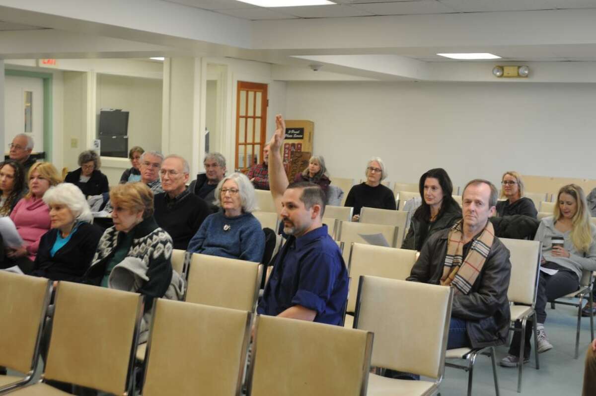 Michael Garguilo raises his hand to speak during Saturday's public hearing in town hall. — Macklin Reid photo
