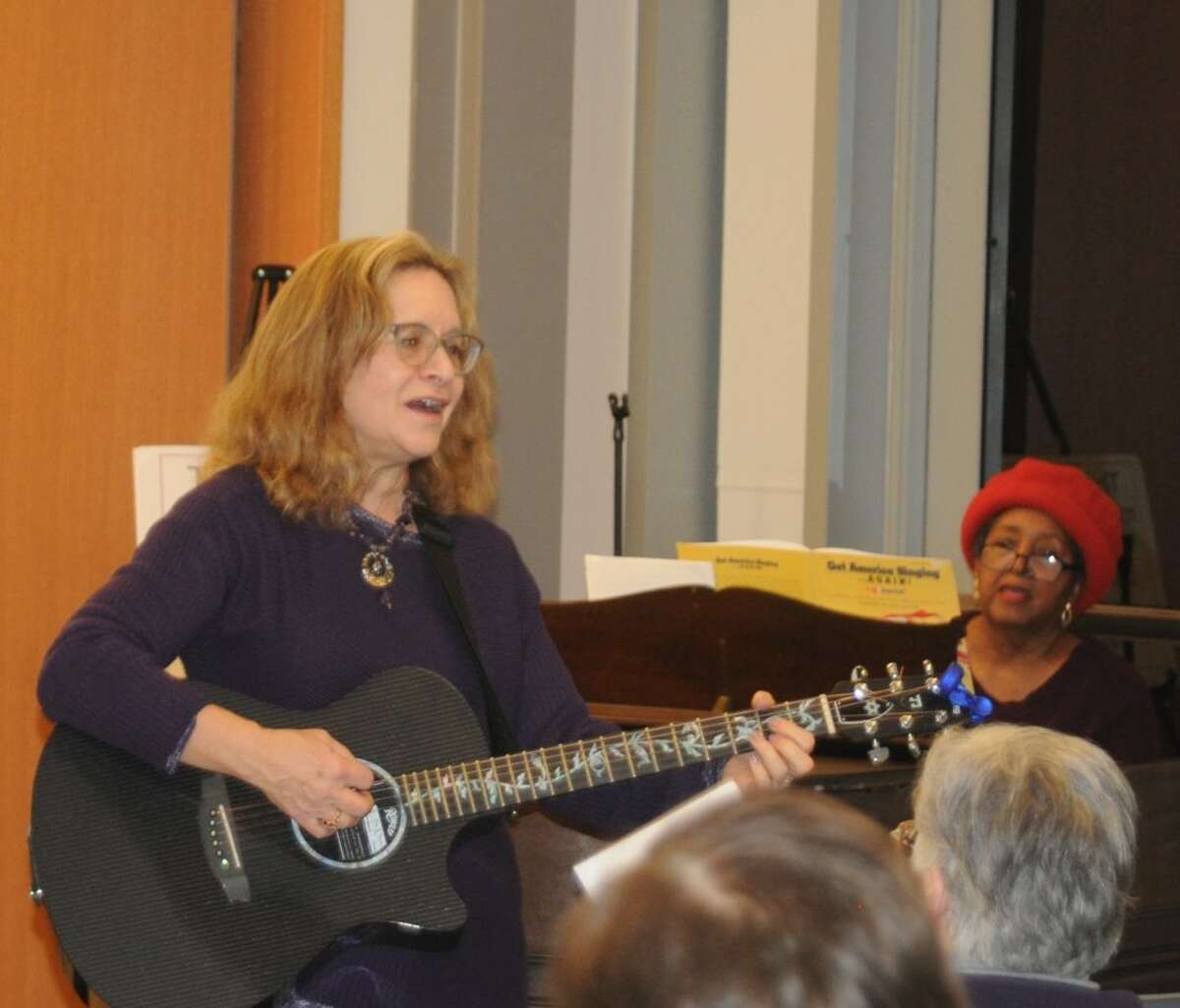 With Deborah Katchko-Gray on guitar and leading the vocals, and Gigi Van Dyke on piano, about 20 people who showed up at the Ridgefield Library had all the musical leadership they needed for a room-rocking community sing-along on Sunday, Dec. 16. Folks joined voices on songs ranging from The Beatles to Billy Joel to standards like Take Me Out to the Ballgame and Woody Guthrie’s This Land is Your Land. Katchko-Gray, the cantor of Congregation Shir Shalom, has been organizing community sing-alongs for a couple of years now. The next one is Jan. 6 from 3:30 to 5 at the library. Songbooks with the words are provided, guitars and other instruments are welcome. — Macklin Reid photo