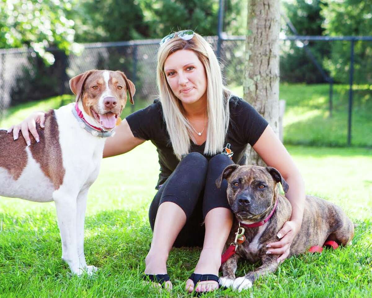 Sarah Roberts, ROAR’s new adoption coordinator with Ranger (left) and Katie (right), two four-legged pals she hopes to have adopted together. Roberts was hired as the adoption coordinator on July 16. — Debbie Rabinowitz photo