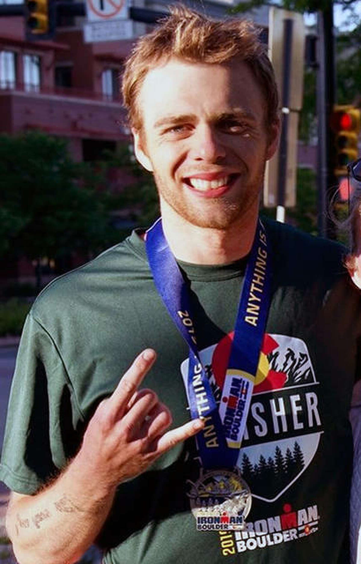 Former Principia College swimmer and baseball player Garrett Barner, a 2019 Principia College grad, recently completed the Ironman Boulder Triathlon in Boulder Colo. Above, he celebrates after his seventh-place finish in the 18-24 age group.
