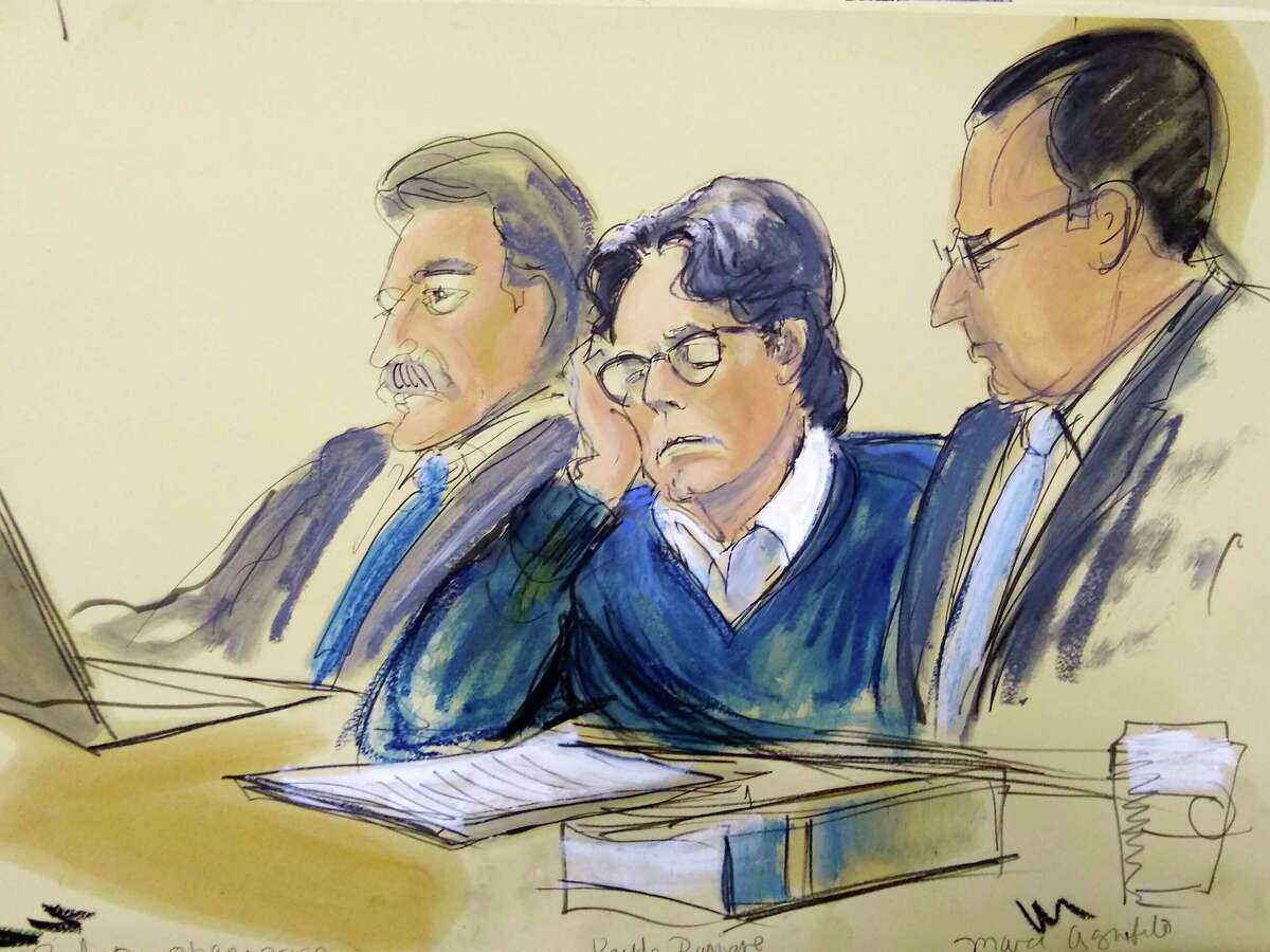In this courtroom artist's sketch, defendant Keith Raniere, center, sits with attorneys Paul DerOhannesian, left, and Marc Agnifilo during closing arguments at Brooklyn federal court, Tuesday, June 18, 2019 in New York. 