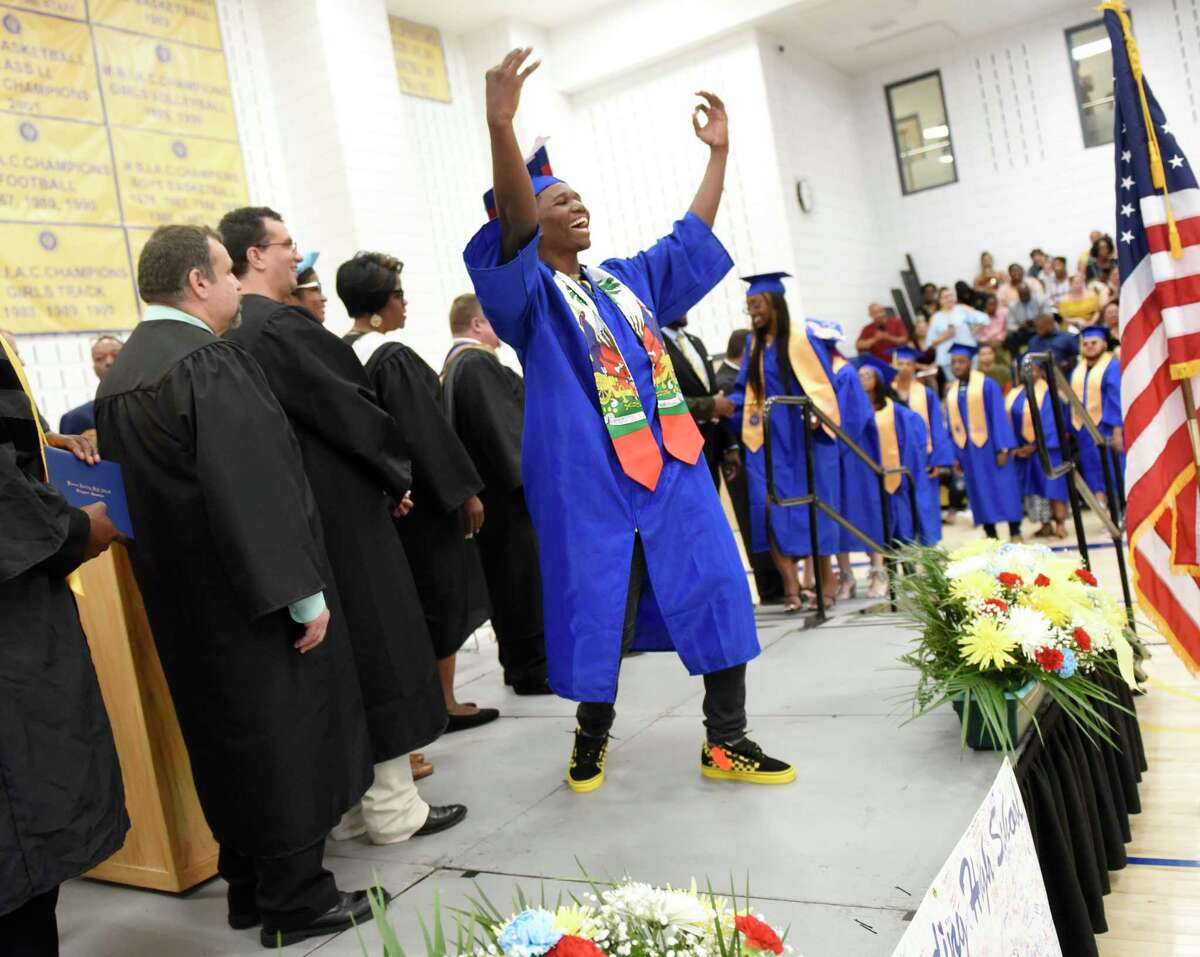 Dodley Faure dances while walking across the stage to receive his diploma at the 93rd Annual Commencement at Warren Harding High School in Bridgeport, Conn. Tuesday, June 18, 2019. The Class of 2019 was the first to graduate from the new Warren G. Harding High School on the long-awaited Bond Street location.