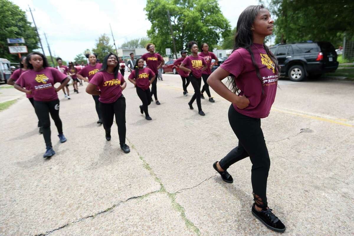 Tiana Clark, 15, leads the Lawson Academy drumline in the Juneteenth Parade as they march past Emancipation Park in Houston, Saturday, June 15, 2019.