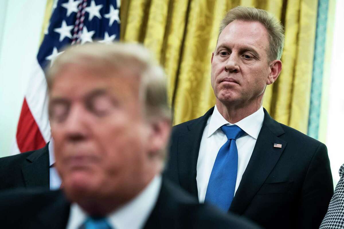 Acting defense secretary Patrick Shanahan listens to President Trump during a signing ceremony at the White House on Feb. 19, 2019.