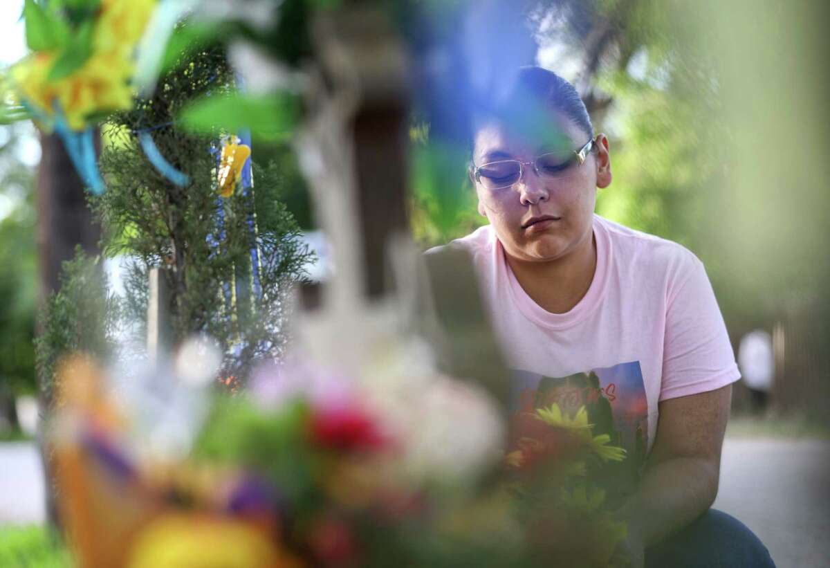 Jessica Molina prays at the site where Josue Flores, an 11-year-old boy, was stabbed to death in May 2016, on Tuesday, June 18, 2019, in Houston. "I have three daughters, and I couldn't even start to imagine how his momma feel," Molina said. "I don't recall anything being done to a child this ugly, it hit everybody hard." Harris County District Attorney Kim Ogg announced that a murder indictment was handed down by a grand jury Tuesday morning against Andre Jackson.