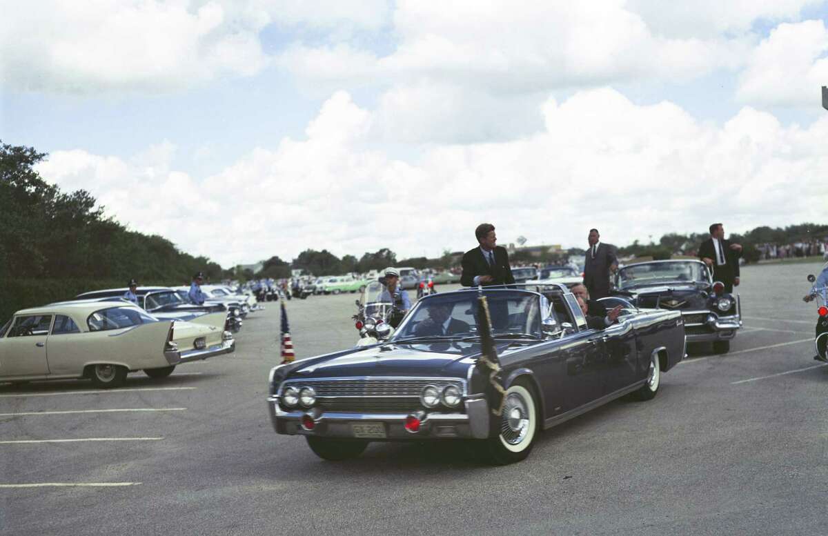 President John F. Kennedy can be easily recognized in this image photographed at the staging area of a 1962 parade featuring him in Houston.