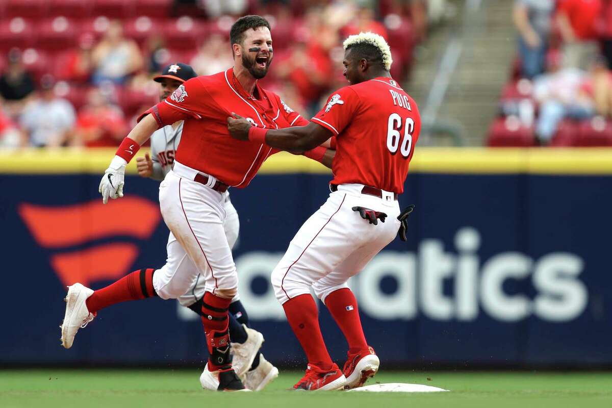 Cincinnati Reds' Jesse Winker, left, celebrates with Yasiel Puig, right, after hitting the game-winning RBI-single in the ninth inning of a baseball game against the Houston Astros, Wednesday, June 19, 2019, in Cincinnati. (AP Photo/Aaron Doster)
