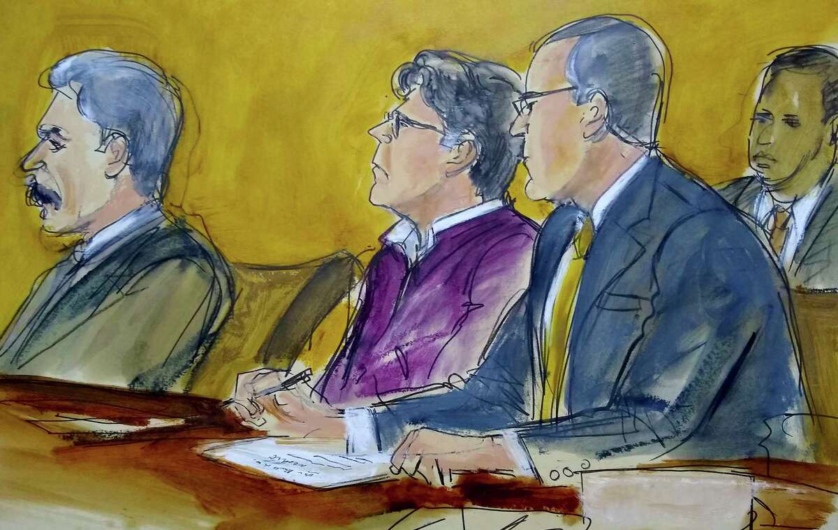 In this courtroom drawing, defendant Keith Raniere, center, sits at the defense table with his attorneys Paul DerOhannesian, left and Marc Agnifilo, as the jury foreperson reads the guilty verdict in his sex trafficking trial in New York, Wednesday, June 19, 2019. The former leader of a cult-like self-help group was convicted Wednesday of manipulating his female followers through shame and humiliation and turning them into what prosecutors call his sex slaves. The man at rear is a Deputy US Marshal.