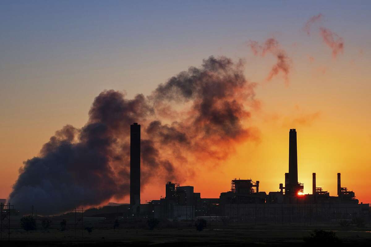 FILE - In this July 27, 2018, file photo, the Dave Johnson coal-fired power plant is silhouetted against the morning sun in Glenrock, Wyo. The Trump administration announced on Wednesday, June 19, 2019, that it has rolled back a landmark Obama-era effort targeting coal-fired power plants and their climate-damaging pollution. (AP Photo/J. David Ake, File)