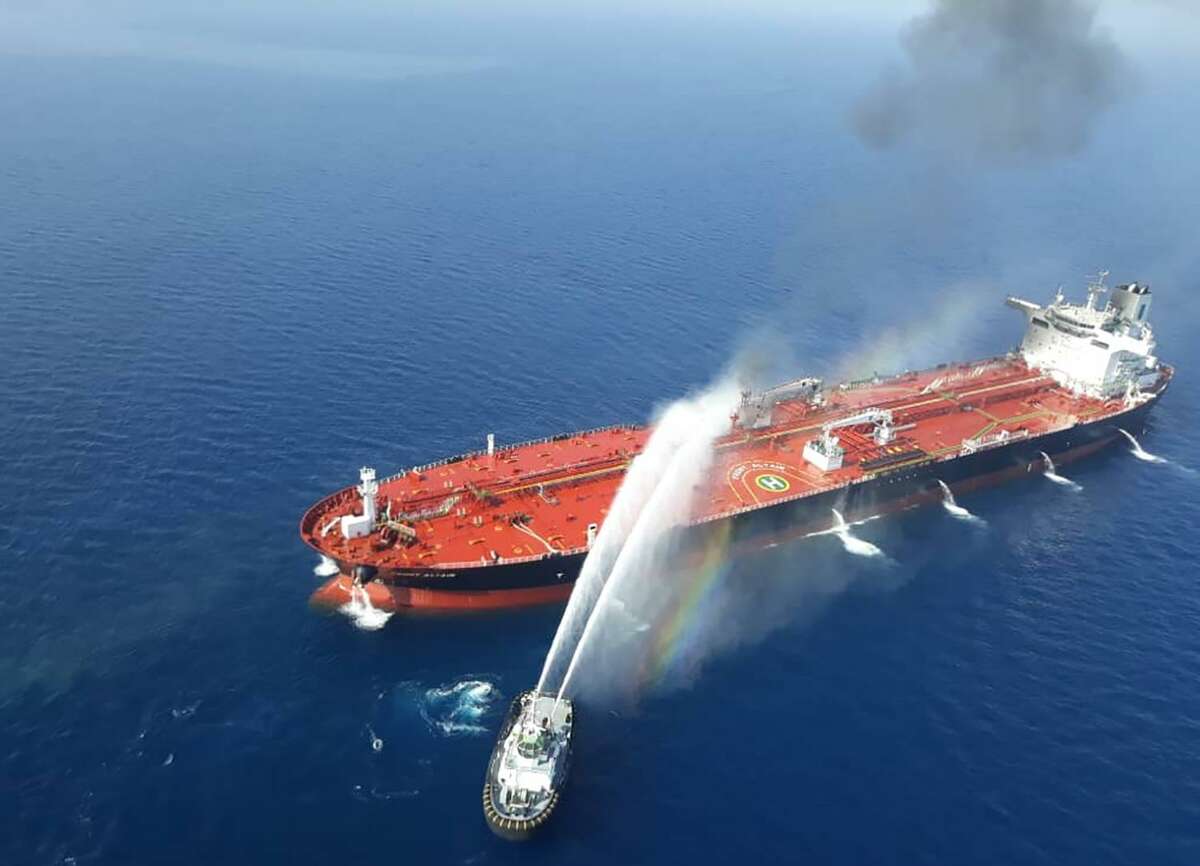In this file picture obtained by AFP from Iranian news agency Tasnim on June 13, an Iranian navy boat trying to control fire from Norwegian owned Front Altair tanker said to have been attacked in the waters of the Gulf of Oman. President Trump has blamed Iran for recent attacks on tankers.