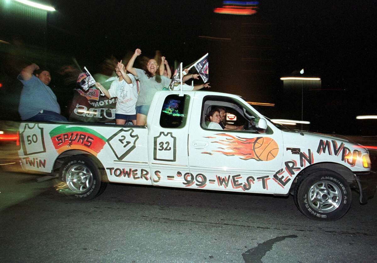San Antonio Spurs fans drive through the streets of San Antonio 26 June, 1999, celebrating the Spurs NBA Championship. The Spurs beat the New York Knicks to win the first championship in franchise history.