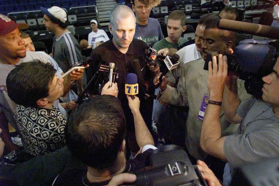 Head Coach Gregg Popovich of the San Antonio Spurs is surrounded by the media as he answers questions after his team's workout June 17, 1999, at the Alamodome in San Antonio.  The Spurs beat the Knicks 89-77 in Game 1 of the NBA Finals to take a 1-0 lead in the best-of-seven series. Photo: Robert Sullivan | AFP, Getty Images