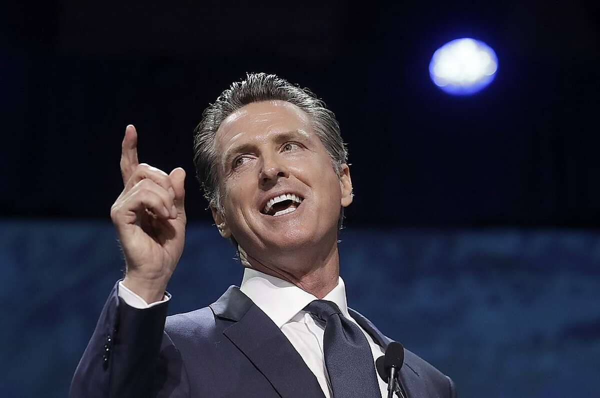 FILE - In this June 1, 2019, file photo, Gov. Gavin Newsom speaks during the 2019 California Democratic Party State Organizing Convention in San Francisco. Newsom and a state lawmaker have agreed to limit the role of public health officials in approving doctors' vaccine decisions. But the health officials will increase their oversight of doctors and schools with high numbers of medical exemptions. Sen. Richard Pan announced the changes Tuesday, June 18 after Newsom said he had doubts about giving state public health officials instead of local doctors the authority to decide which children can skip their shots before attending school. (AP Photo/Jeff Chiu, File)