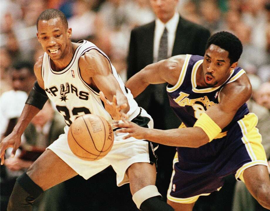 San Antonio Spur Sean Elliott and Los Angeles Laker Kobe Bryant fight for the basketball during first quarter action in Game 1 of the Western Conference semifinal May 17, 1999, at the Alamodome. Photo: Paul Buck | AFP, Getty Images