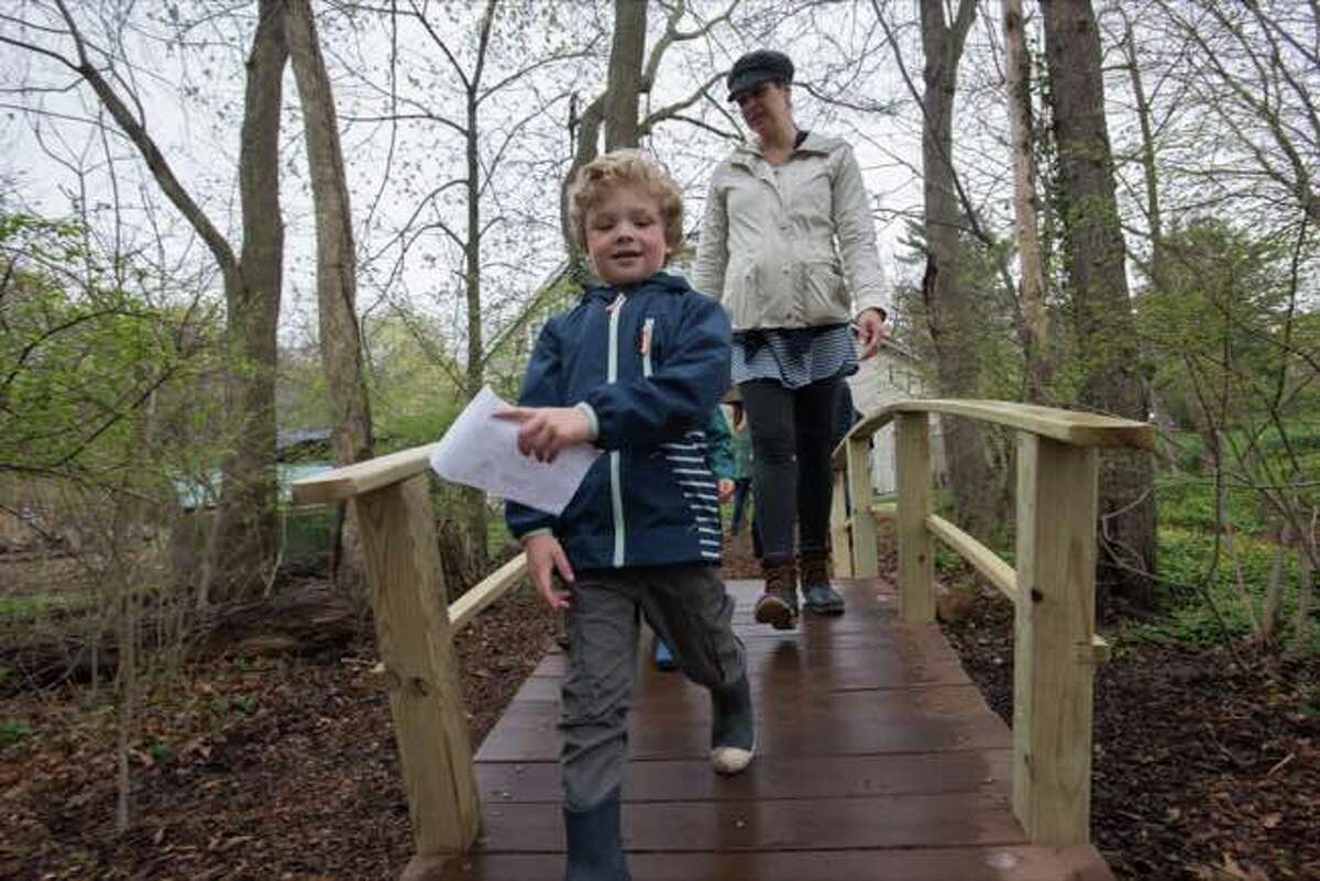 Luca, Riley and Julie Seguss cross the bridge