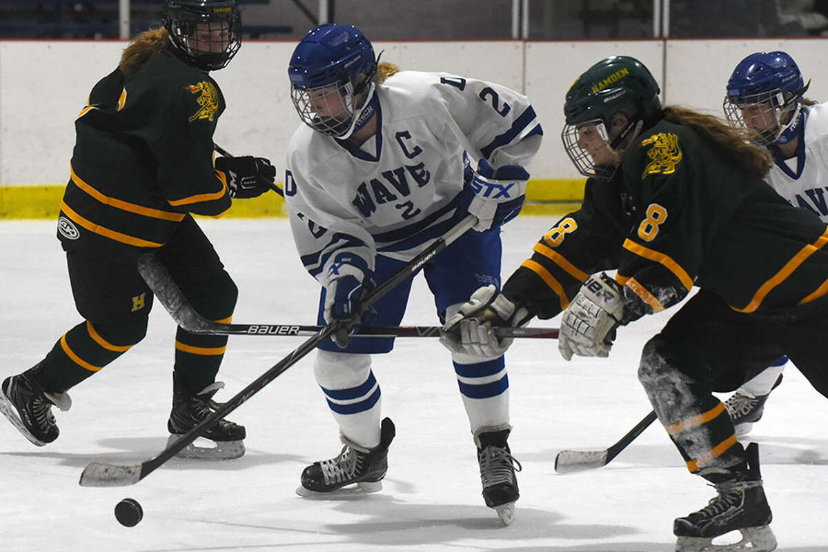 Darien's Colleen Cassidy (2) and Hamden's Claire Boncek battle for the puck during a girls ice hockey game at the Darien Ice House on Dec. 5.- Dave Stewart photo