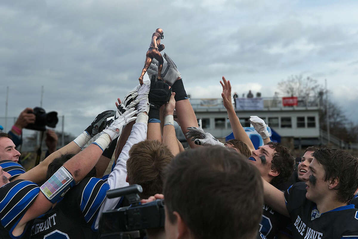 The 2015 Darien Blue Wave hoist the Coaches Memorial Trophy, awarded to the winner of the Turkey Bowl each season. -Dave Stewart photo