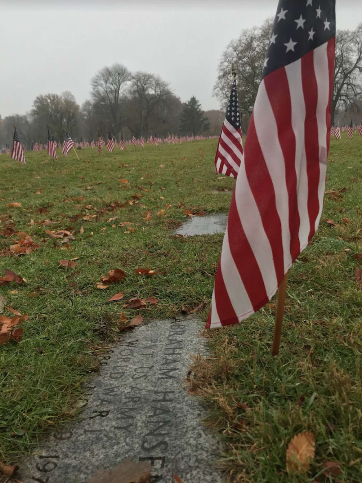 A flag is placed on every grave in Darien’s historic Veterans Cemetery at Spring Grove. The graves represent veterans from as far back as World War I, including this one. — Susan Shultz photo