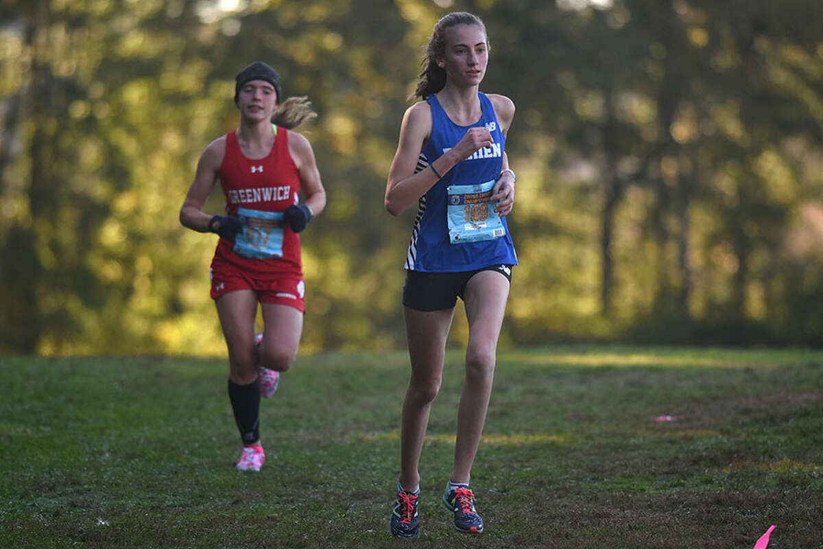 Darien freshman Mairead Clas, shown competing at the FCIAC cross country championships in October, won the 1,000-meter race at he FCIAC East Division indoor track and field championships in Wilton on Saturday, Jan. 26. - Dave Stewart photo