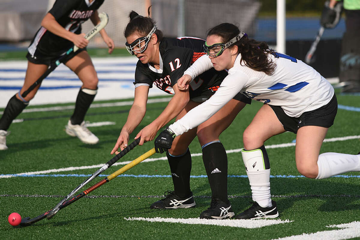 Darien's Bridget Mahoney (right) and Ridgefield's Isabella Carrozza (12) battle in the Tigers' circle during the FCIAC quarterfinals last Friday at DHS. — Dave Stewart photo