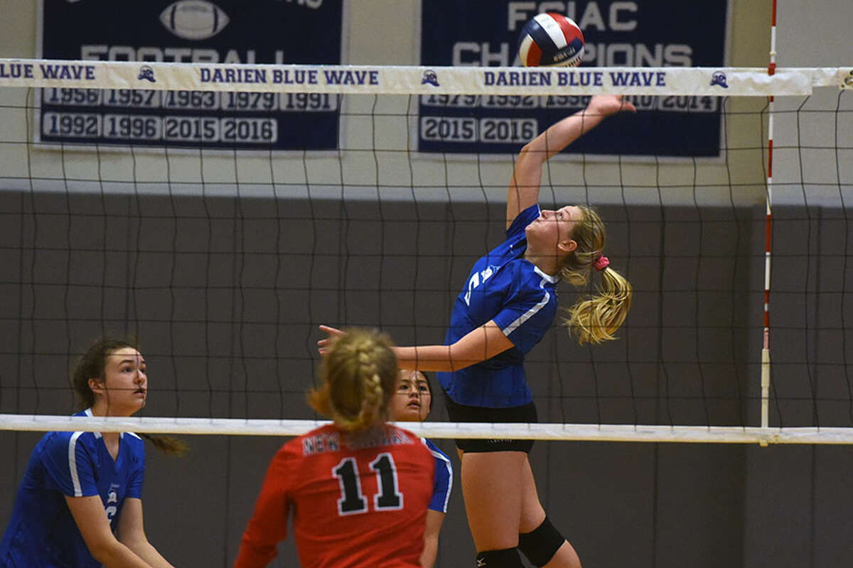 Darien senior co-captain Lindsey Bennett takes to the air during the Wave's 3-0 win over New Canaan Thursday at DHS. — Dave Stewart photo