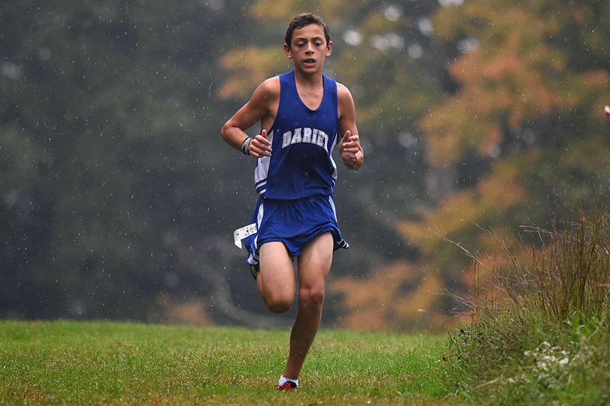 Darien's Cormac Brown races through the rain drops during a dual meet in New Canaan's Waveny Park on Oct. 2. Brown finished fourth at that meet, and was sixth at the Wickham Park Invitational on Saturday, Oct. 6. - Dave Stewart photo
