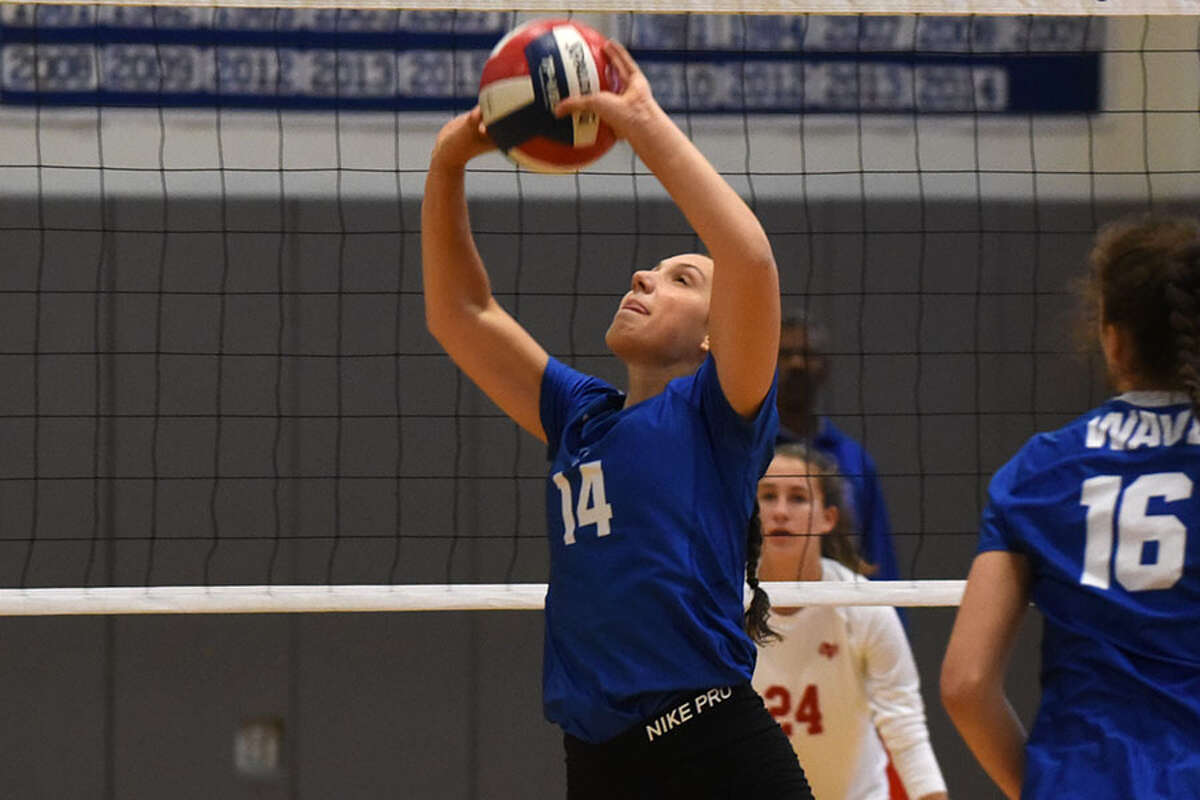 Darien senior co-captain Cristina Escajadillo sets the ball during a recent Wave win. - Dave Stewart photo