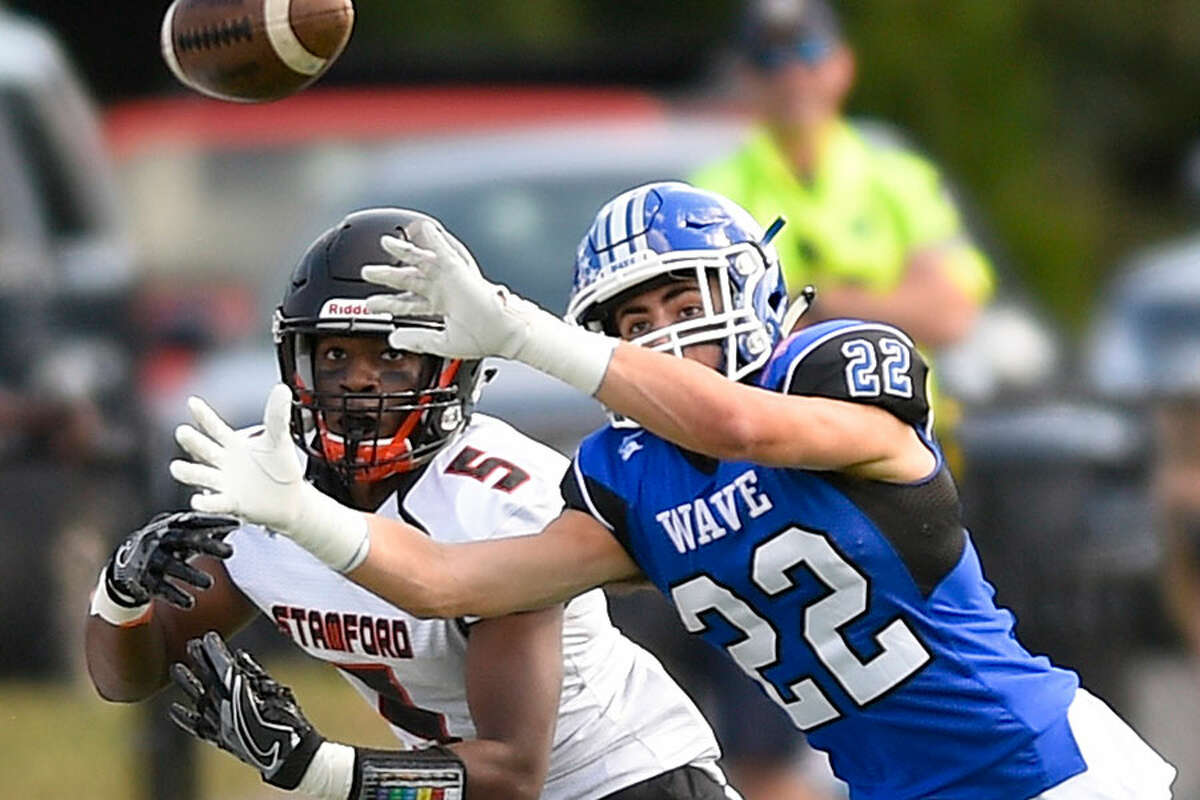 Darien's Jackson Peters (22) lines up a catch during a football game against Stamford in Darien last September. - Matthew Brown/Hearst Connecticut Media