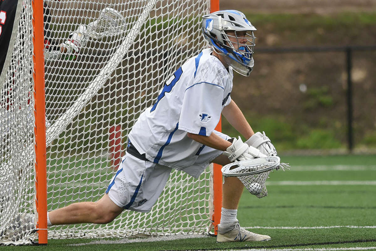 Sean Collins looks to clear after making one of his 12 saves in the Class L semifinals against New Canaan. - Dave Stewart photo