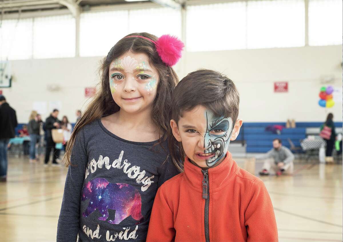 Seven-year-old Elena Cappella and her brother, Neil, 5, show off their freshly painted faces.