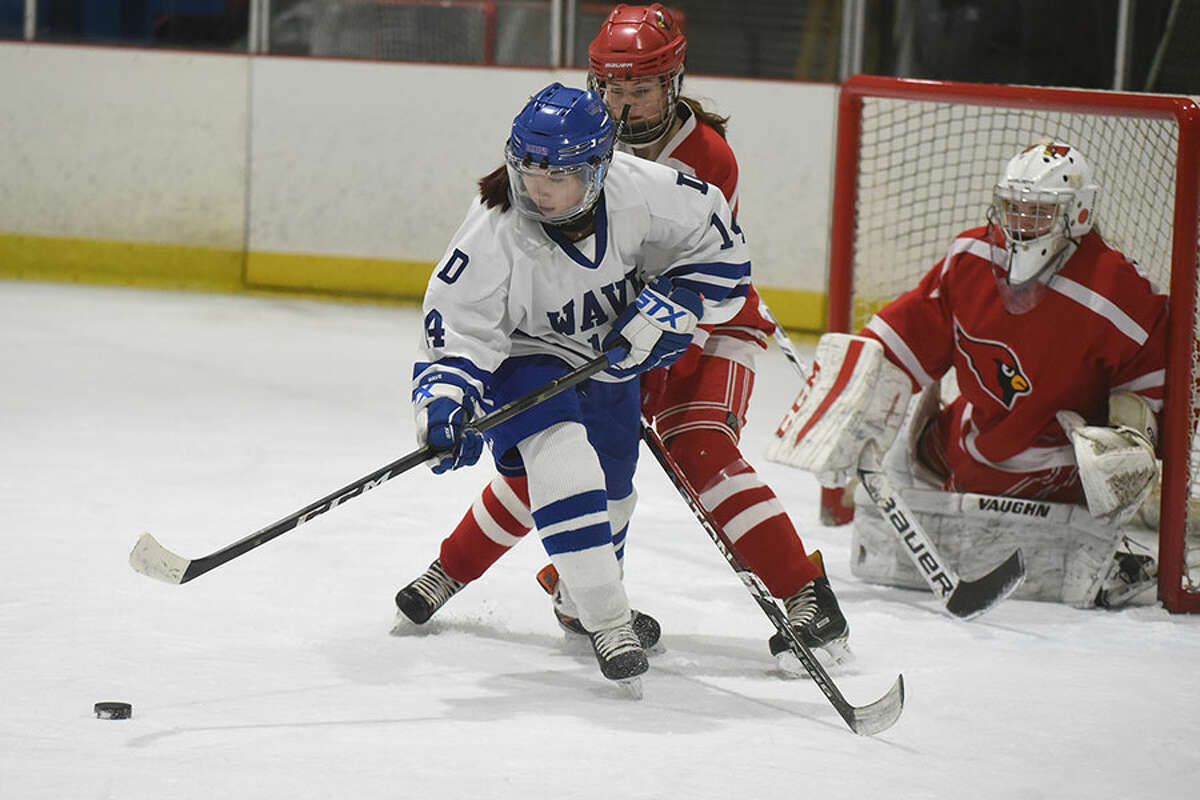 Darien’s Caitlin Chan (14) gets to the puck in front of the Greenwich goal during the girls hockey state quarterfinals at the Darien Ice House on Saturday, March 2. — Dave Stewart/Hearst Connecticut Media