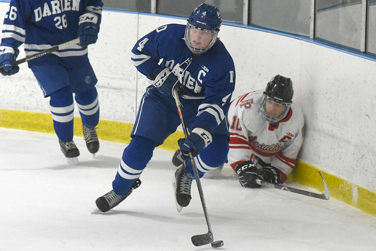 Darien's CJ Hathaway wins the puck behind the net during the Wave's 4-3 overtime victory against Fairfield Prep at the Wonderland of Ice on Saturday, Jan. 19. - Dave Stewart/Hearst Connecticut Media photo