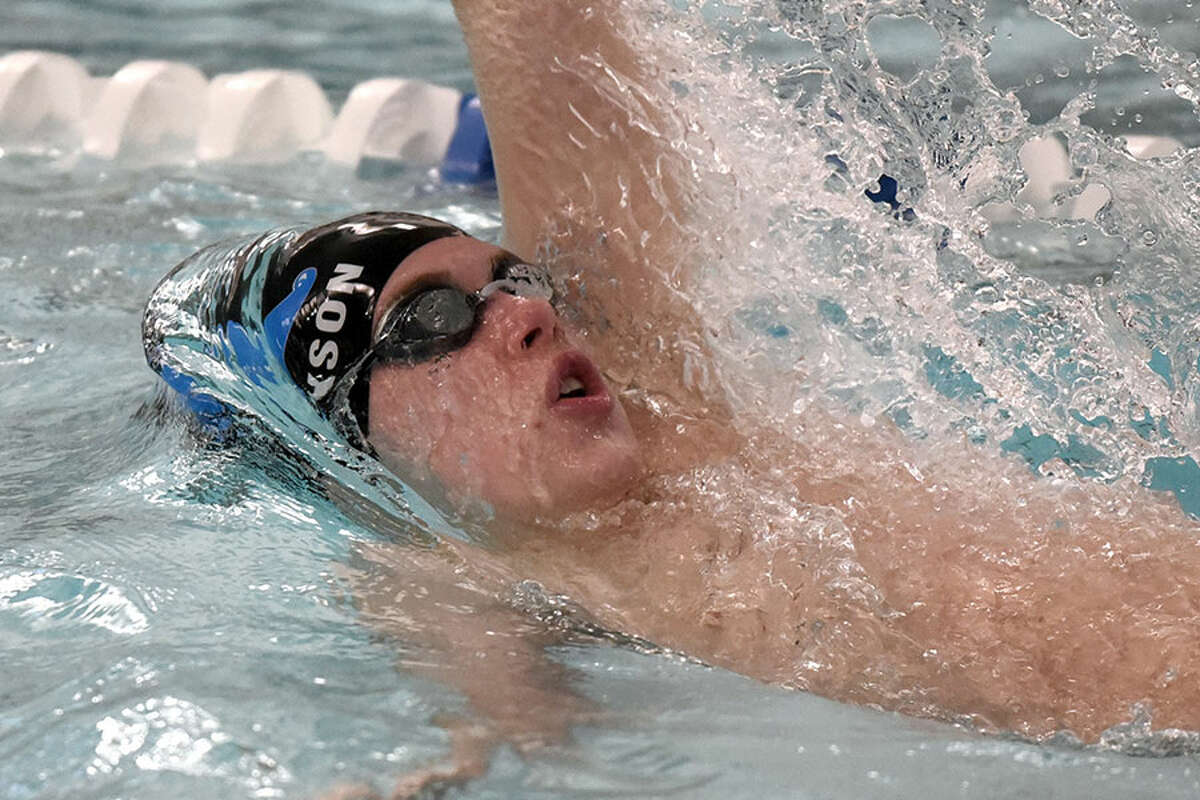 Darien’s Spencer Erickson swims in the 100 backstroke during a swim meet at the New Canaan YMCA on Wednesday, Jan. 23. — Dave Stewart/Hearst Connecticut Media