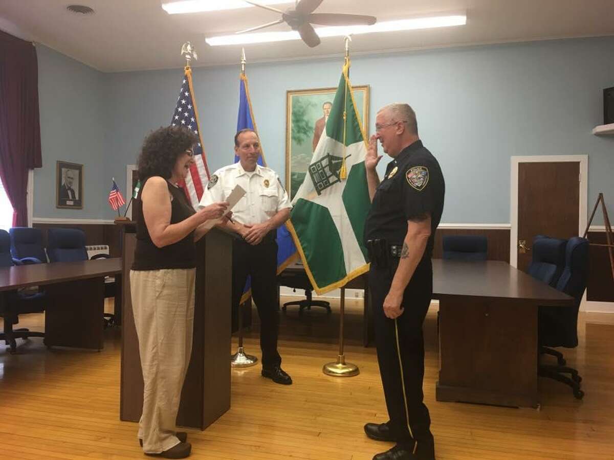 After eight years as a New Milford police lieutenant, Lawrence Ash, right, was sworn in as captain on June 19, 2019. He was joined at the ceremony by Chief Spencer Cerruto, center.