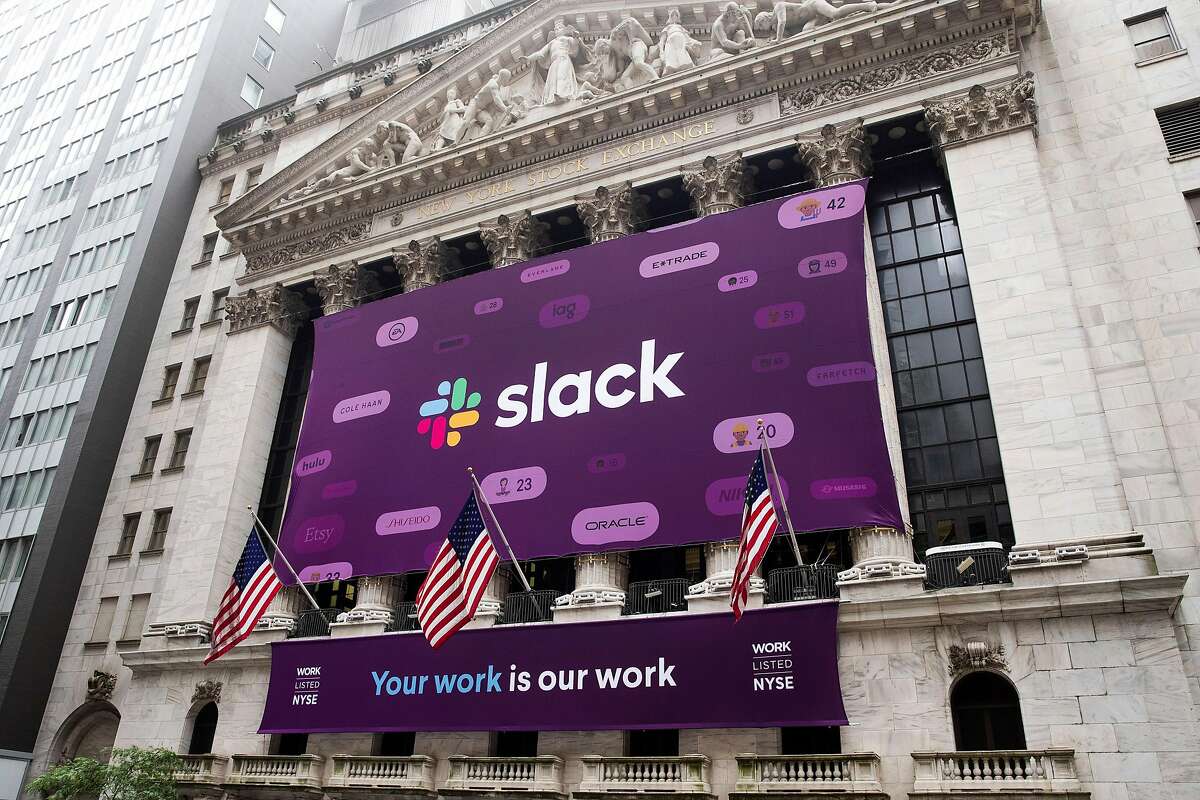 Signs for Slack at the New York Stock Exchange on the day of the workplace collaboration company's initial public offering, in Manhattan, June 20, 2019. Slack shares soared on Thursday in early trading, a sign that Wall Street remains tantalized by fast-growing young technology firms even after the recent lackluster public offerings of companies like Uber. (Brittainy Newman/The New York Times)