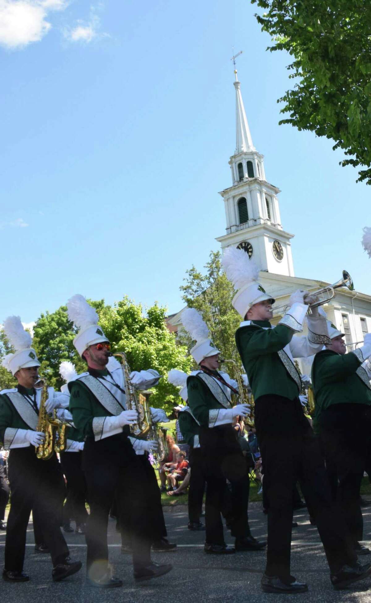Spectrum/New Milford recognized Memorial Day with a ceremony in front of the New Milford Public Library, followed by a parade downtown. May 27, 2019. Above, members of the New Milford High School band march along Main Street, with the First Congregational Church in the background.