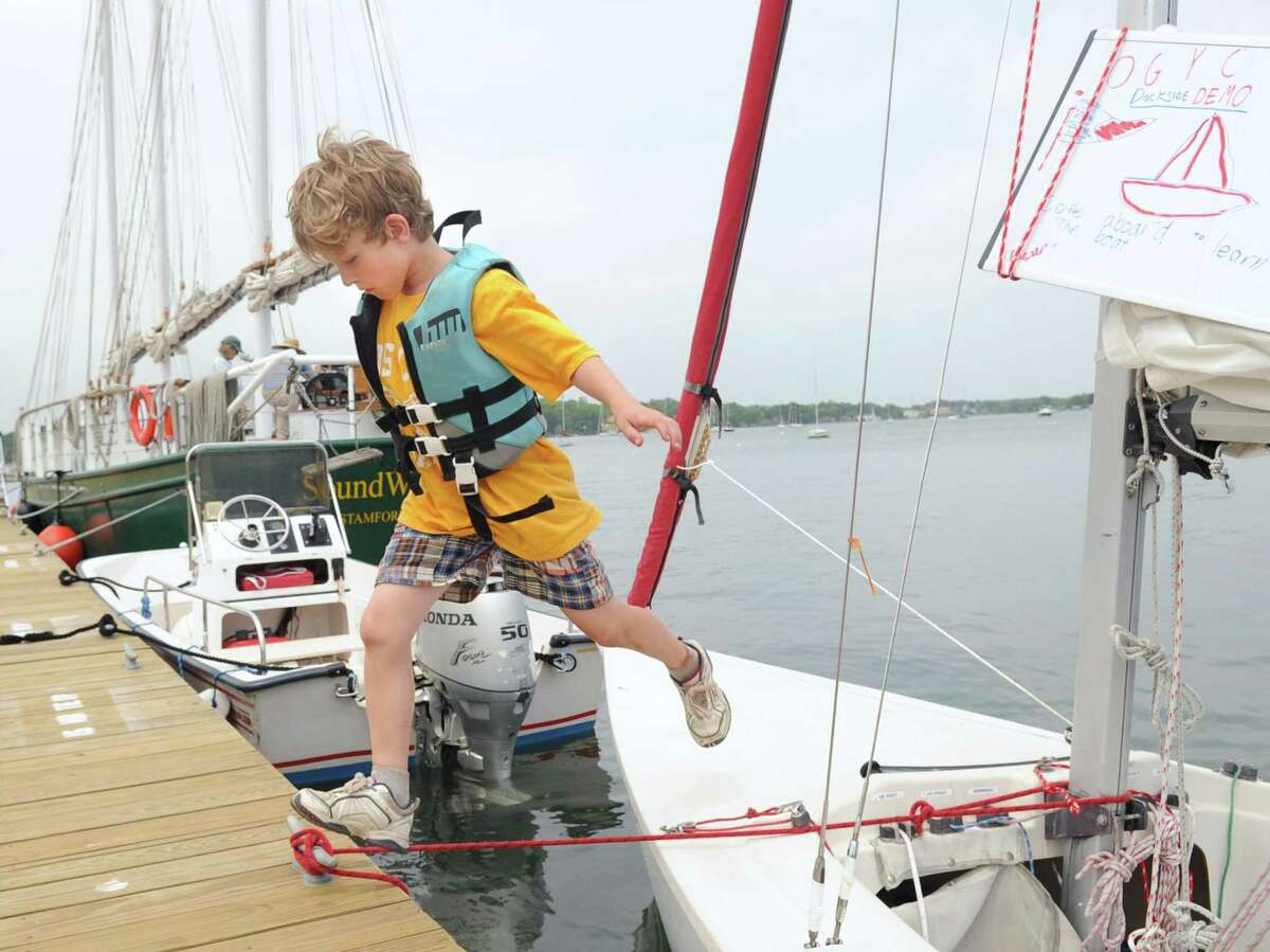 A youngster jumps off a small sailboat during a previous "Experience the Sound" event at Greenwich Point. This year’s event will run from 1 to 4 p.m. Sunday. Parking and participation are free — and no beach pass is required to attend. Families can learn about history, ecology, environmental stewardship, and outdoor sports. Activities will take place around the Innis Arden Cottage, the Old Greenwich Yacht Club and its docks. A free shuttle bus will be available to take participants to and from both areas.